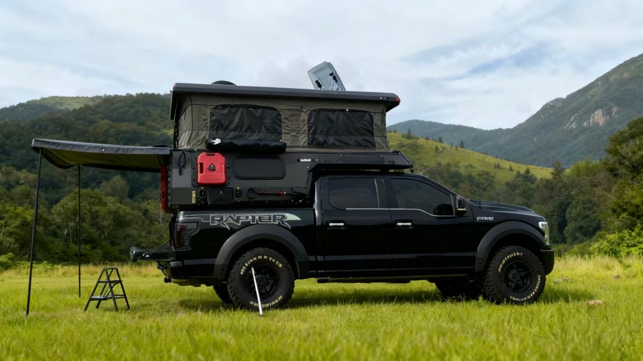 Truck camper set up at an outdoor campsite
